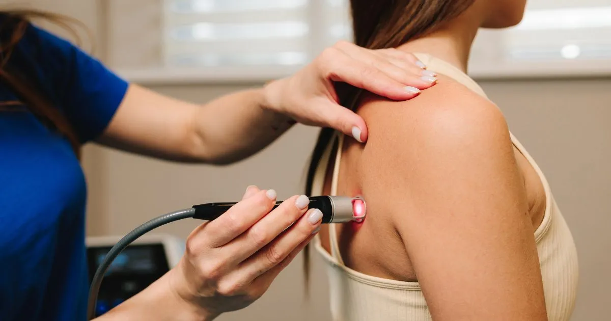 A practitioner performs Laser Therapy for Pain in Denville, NJ on a patient's back