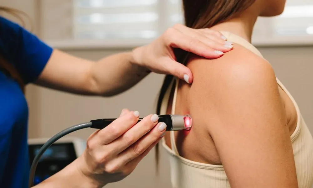 A practitioner performs Laser Therapy for Pain in Denville, NJ on a patient's back